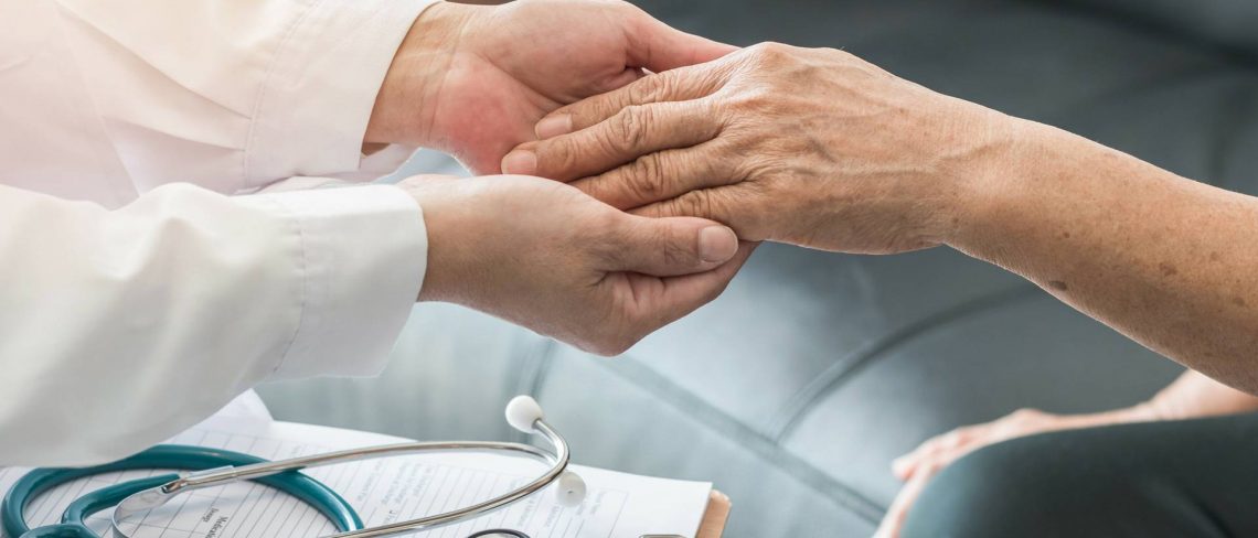elder attorney - Nurse holding hands of elderly person