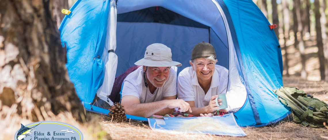 Elderly couple in a tent on vacation.
